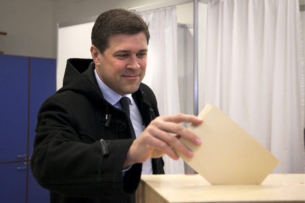 Chairman of the Independence Party Bjarni Benediktsson casts his ballot Saturday April 27, 2013, as Icelanders vote in a General Election.  According to polls the parliamentary election could return to power the center-right parties that led the country into economic collapse five-years ago, "The government that many people thought was cleaning up the mess is getting severely punished for the last four years," said political analyst Egill Helgason. (AP Photo/Brynjar Gauti)