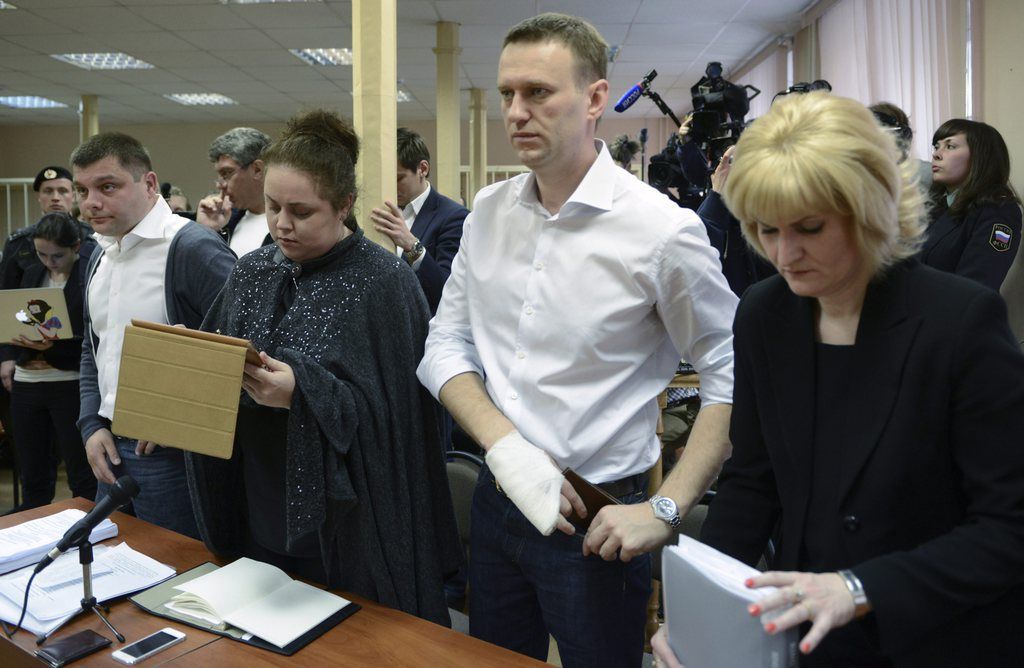 Russian opposition leader Alexey Navalny, second right, stands while listening to a judge in a courtroom during a trial in Kirov, Russia, Wednesday, April 17, 2013.  The trial of Navalny accused of embezzling half a million dollars' worth of timber from a state-run company was adjourned shortly after its start Wednesday in the northwestern city. (AP Photo/Mitya Aleshkovskiy)