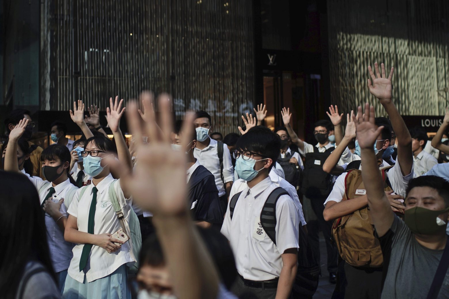 Protesters wear masks and hold up their hands to represent their five demands in Hong Kong Friday, Oct. 4, 2019. Hong Kong pro-democracy protesters marched in the city center Friday ahead of plans by the city's embattled leader to deploy emergency powers to ban people from wearing masks in a bid to quash four months of anti-government demonstrations. (AP Photo/Felipe Dana) Hong Kong Protests