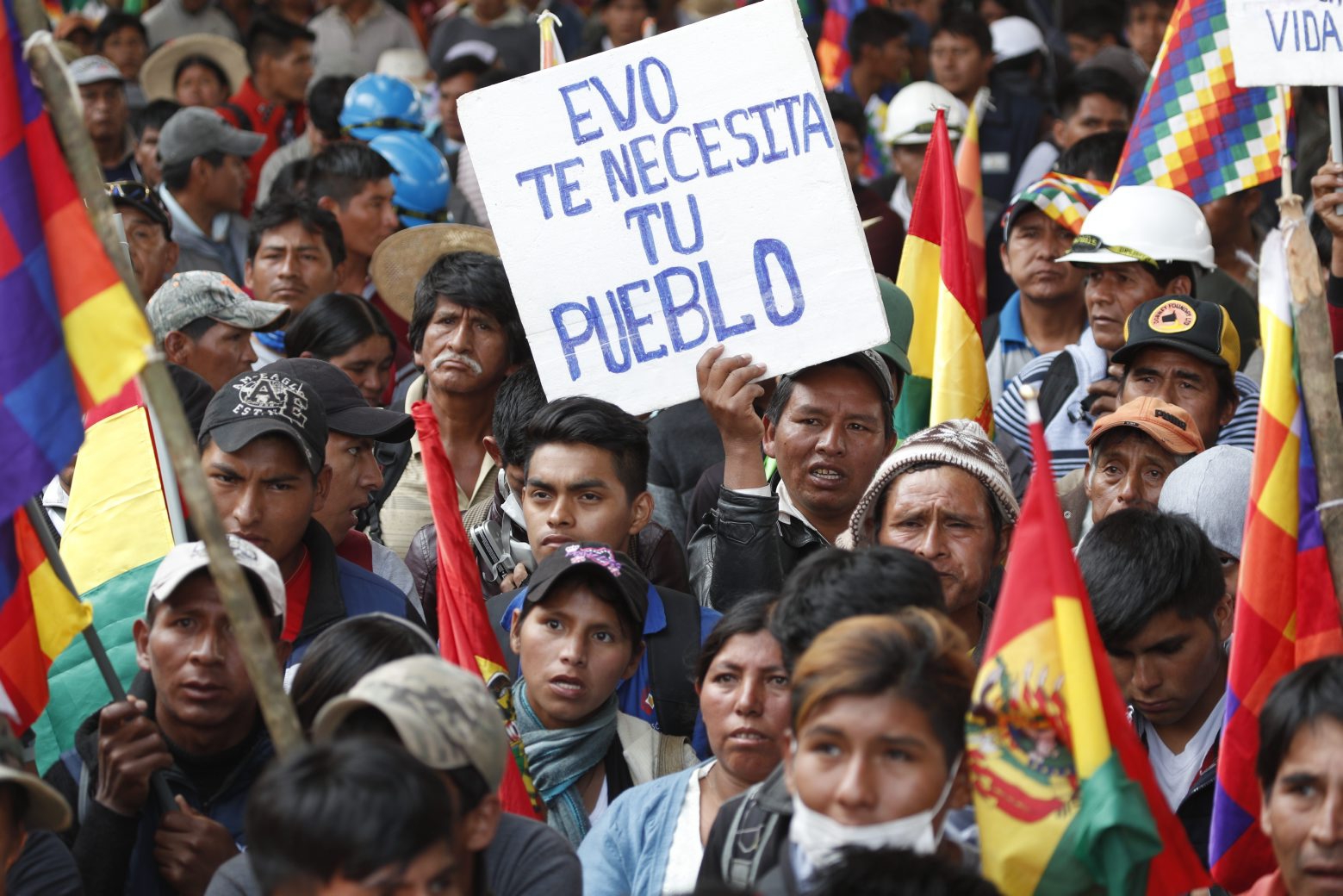 A man holds a sign with a message that reads in Spanish: "Evo, your people need you," as coca leaf producers, supporters of former President Evo Morales, gather to march to Cochabamba from Sacaba, Bolivia, Friday, Nov. 15, 2019. Evo Morales, BoliviaÄôs first indigenous president, resigned on Sunday at military prompting, following massive nationwide protests over suspected vote-rigging in an Oct. 20 election in which he claimed to have won a fourth term in office. An Organization of American States audit of the vote found widespread irregularities. (AP Photo/Juan Karita) Bolivia Protests