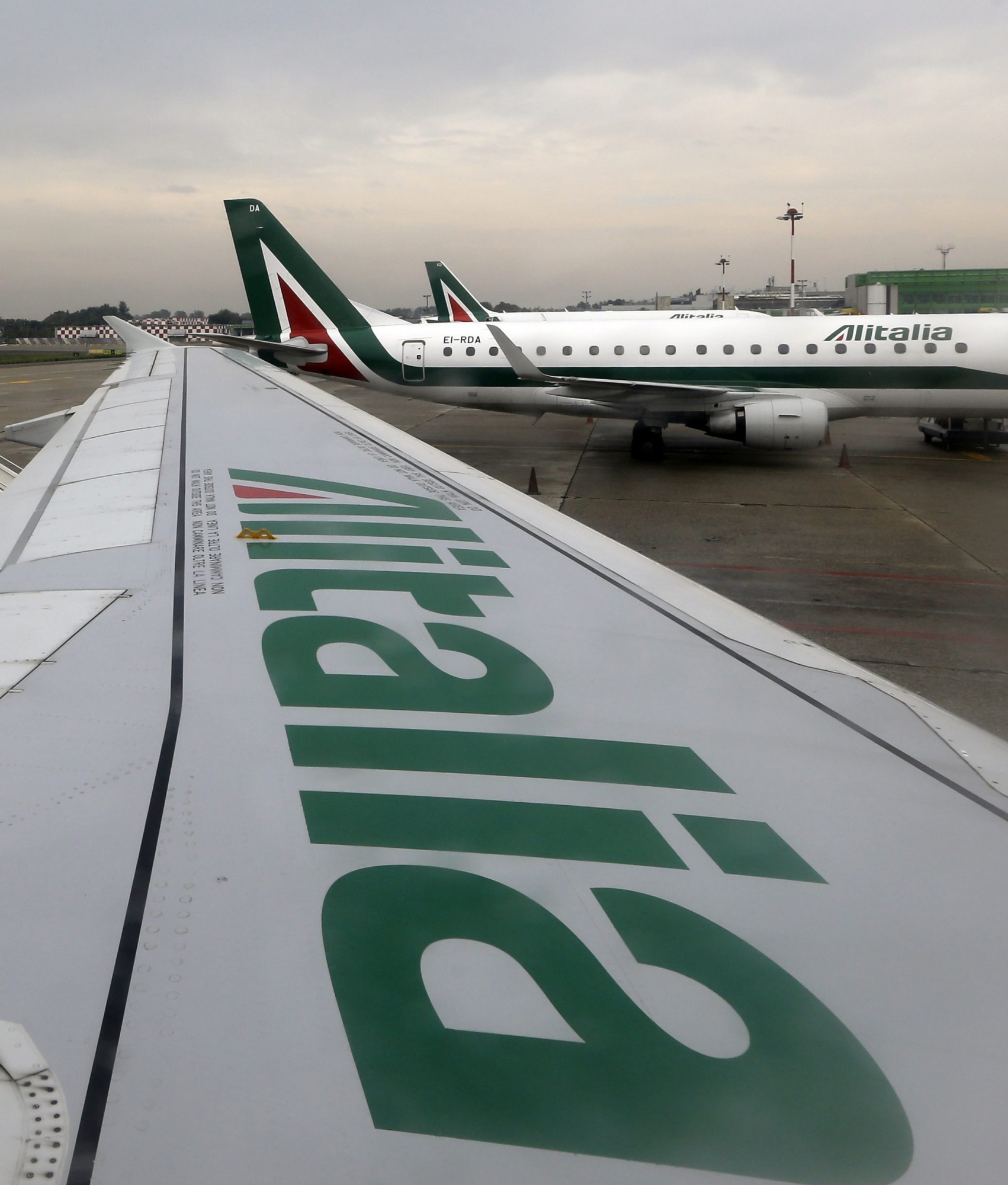 Alitalia planes are waiting on the tarmac at the Linate airport in Milan, Italy, Tuesday, Oct. 8, 2013. Struggling Italian airline Alitalia is asking shareholders to approve a capital increase of at least 100 million euro ($135 million). Alitalia said an extraordinary shareholders meeting on Oct. 14 will deliberate the capital increase, approved by the board at a meeting last Thursday in Rome. News reports say Air France is considering boosting its stake in Alitalia.  (AP Photo/Luca Bruno) Italy Alitalia