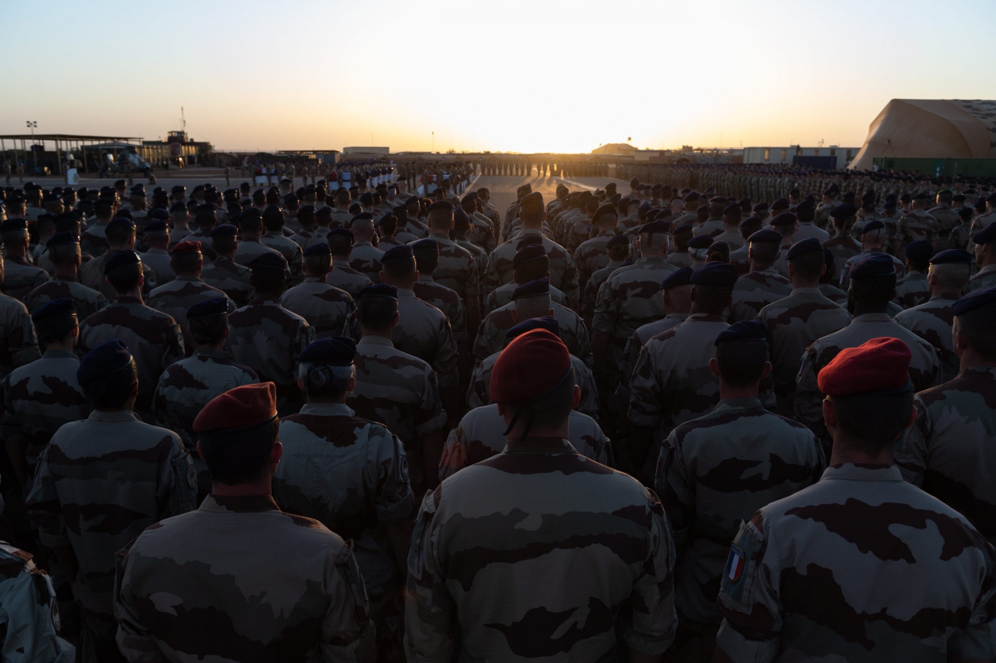 epa08037026 A handout photo made available by French Defense Communication and Audiovisual Department (ECPAD) shows French soldiers paying their respects as coffins are transported by plane to France for a funeral ceremony, at a military base in Gao, Mali, 30 November 2019. (issued 01 December 2019). Thirteen French soldiers have died in an accident involving two helicopters during the Barkhane operation against jihadists in Mali on 25 November. A national tribute will be paid on 02 December at the Hotel National des Invalides in Paris. EPA/THOMAS PAUDELEUX HANDOUT HANDOUT EDITORIAL USE ONLY/NO SALES MALI FRANCE ARMY ACCIDENT