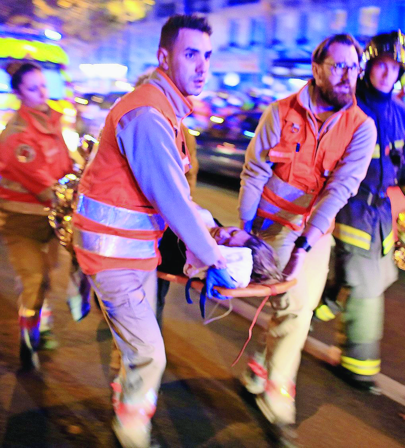 FILE - In this Nov.13, 2015 file photo, a woman is being evacuated from the Bataclan concert hall after a shooting in Paris. All the attackers and accomplices so far identified were raised in Europe, native French speakers with roots in the marginalized immigrant communities of France and Belgium. Minor players, like the man who rented a room to the attacks' mastermind, Abdelhamid Abaaoud, have a degree or two of separation in an underworld of drugs, fraud and theft. (AP Photo/Thibault Camus, File) FRANKREICH TERRORISMUS ANSCHLAEGE PARIS