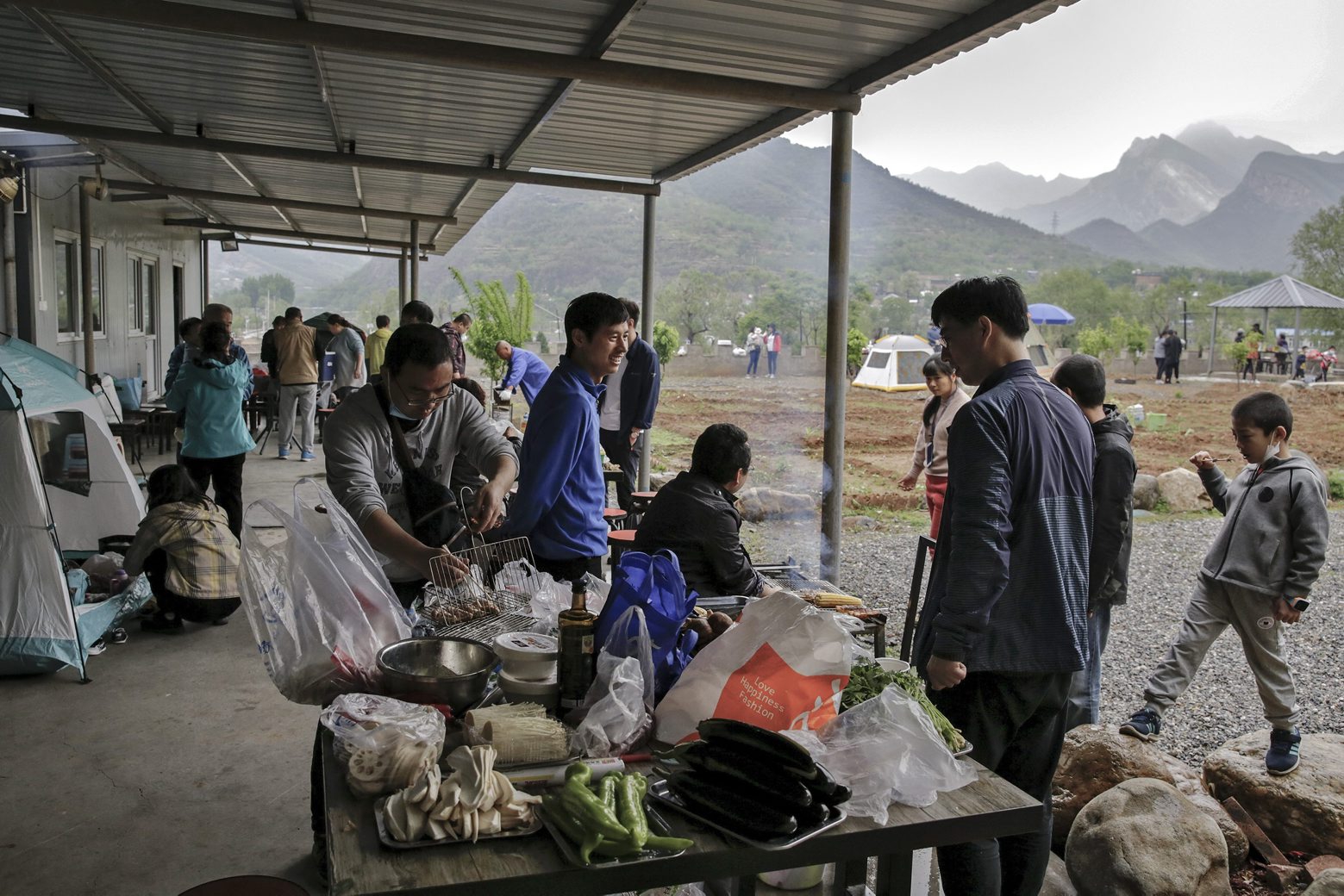 People gather for a barbecue at a scenic area in Fangshan district in Beijing, Monday, May 4, 2020, after authorities loosened up nationwide restrictions following months of lockdown over the new coronavirus outbreak. China reported three new coronavirus cases Monday, all brought from overseas, and no additional deaths. (AP Photo/Andy Wong) Virus Outbreak China