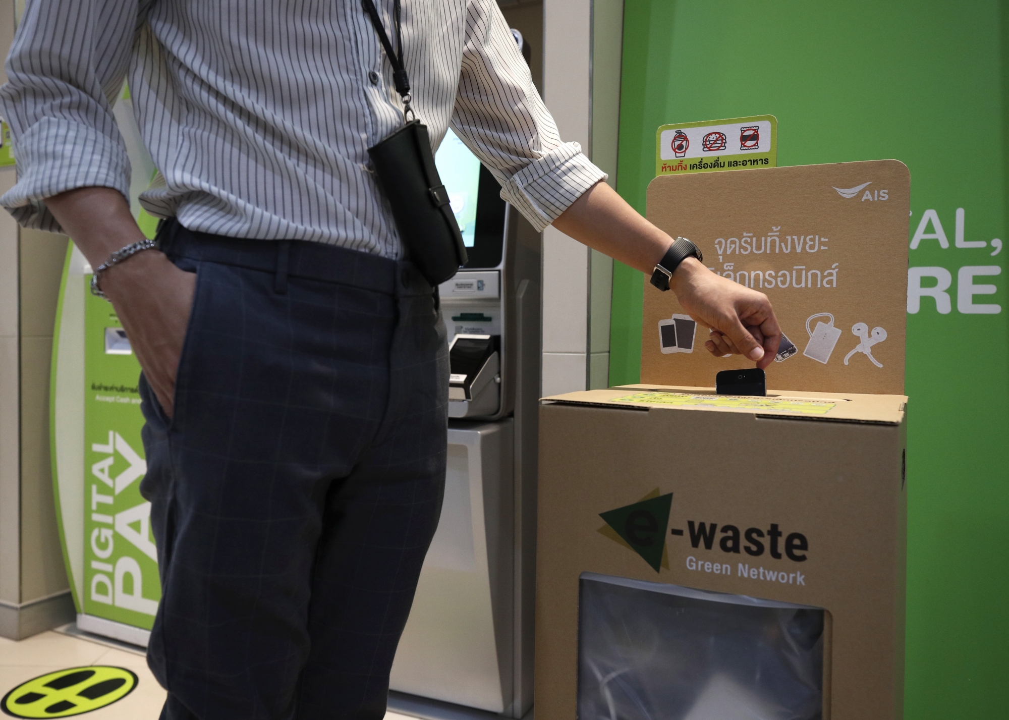 epa08484359 A person drops a mobile phone into an electronic waste disposal bin at an Advanced Info Service (AIS) shop in Bangkok, Thailand, 05 June 2020 (issued 14 June 2020). Thailand's AIS, a mobile phone operator company, launched its electronic wastes disposal campaign by setting up recycled bins across the country and encouraging people to drop off their electronic waste such as broken mobile phones, earphones, adaptors, old tablets, batteries and other e-waste. Thailand has exceeded 400,000 tons of hazardous waste from electronic appliances.  EPA/RUNGROJ YONGRIT
ArcInfo