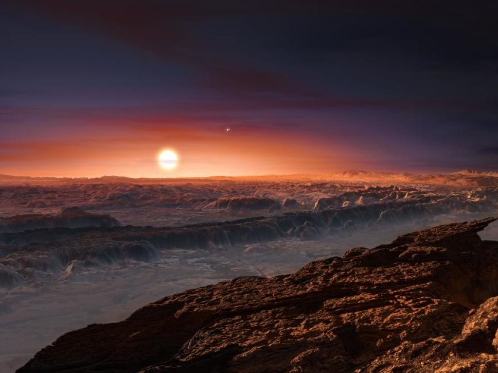 Vue d'artiste de la surface de Proxima b, une planète extrasolaire de la taille de la Terre en orbite autour de l'étoile Proxima du Centaure.