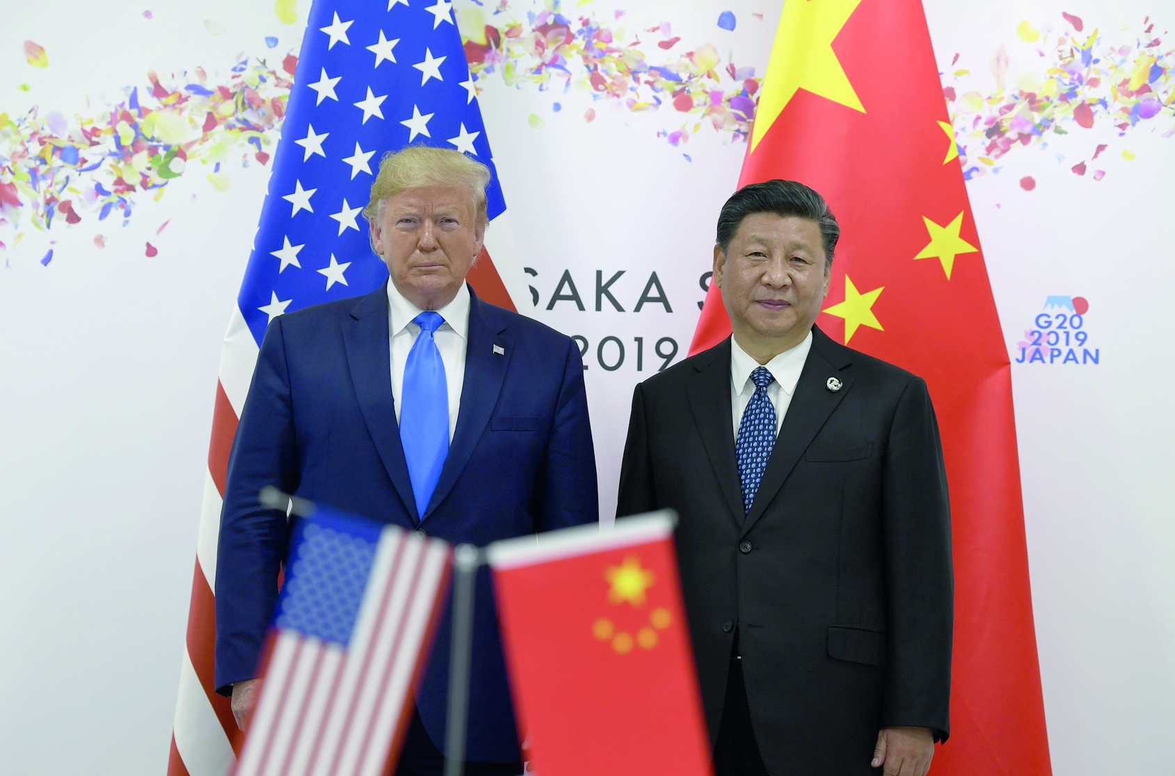 FILE - In this June 29, 2019, file photo President Donald Trump, left, poses for a photo with Chinese President Xi Jinping during a meeting on the sidelines of the G-20 summit in Osaka, Japan. China has fast become a top election issue as President Donald Trump and Democrat Joe Biden engage in a verbal brawl over who's better at playing the tough guy against Beijing. (AP Photo/Susan Walsh, File) Donald Trump,Xi Jinping ArcInfo