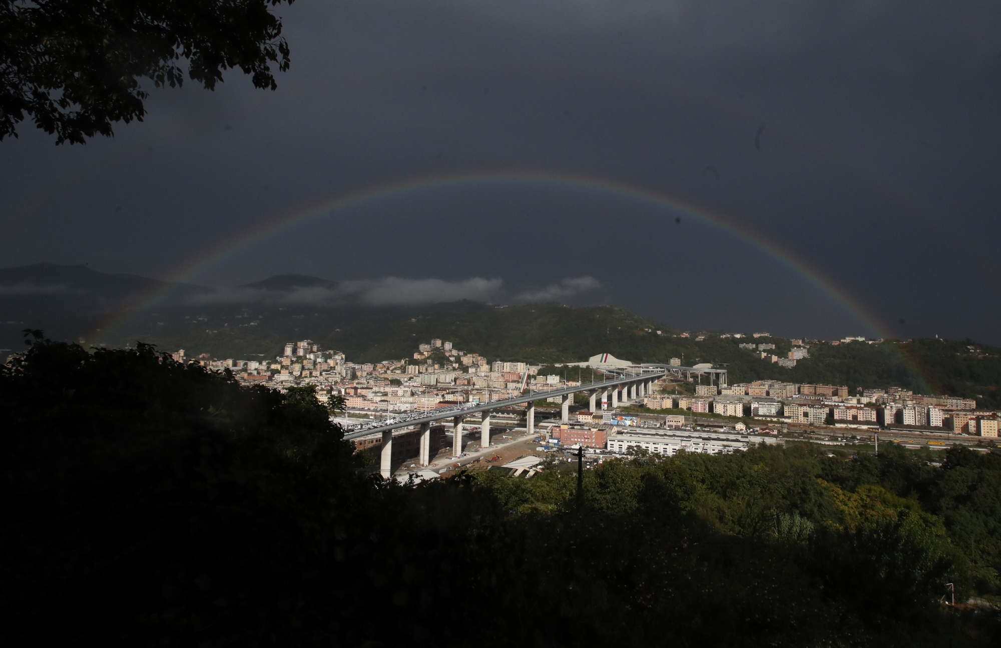 A rainbow shines over the new San Giorgio Bridge in Genoa, Italy, Monday, Aug. 3, 2020. A large section of the old Morandi bridge collapsed on Aug. 14, 2018, killing 43 people and forcing the evacuation of nearby residents from the densely built-up area. (AP Photo/Antonio Calanni) ArcInfo