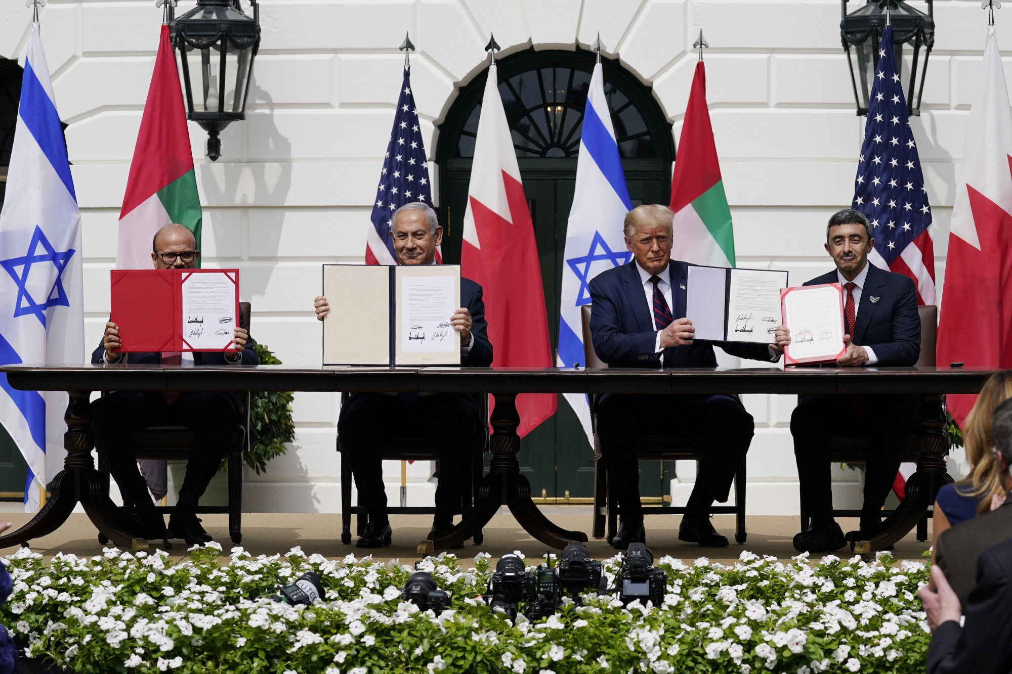 President Donald Trump, center, with from left, Bahrain Foreign Minister Khalid bin Ahmed Al Khalifa, Israeli Prime Minister Benjamin Netanyahu, Trump, and United Arab Emirates Foreign Minister Abdullah bin Zayed al-Nahyan, during the Abraham Accords signing ceremony on the South Lawn of the White House, Tuesday, Sept. 15, 2020, in Washington. (AP Photo/Alex Brandon) ArcInfo